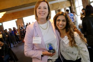 Yvonne and Naseam stand together smiling